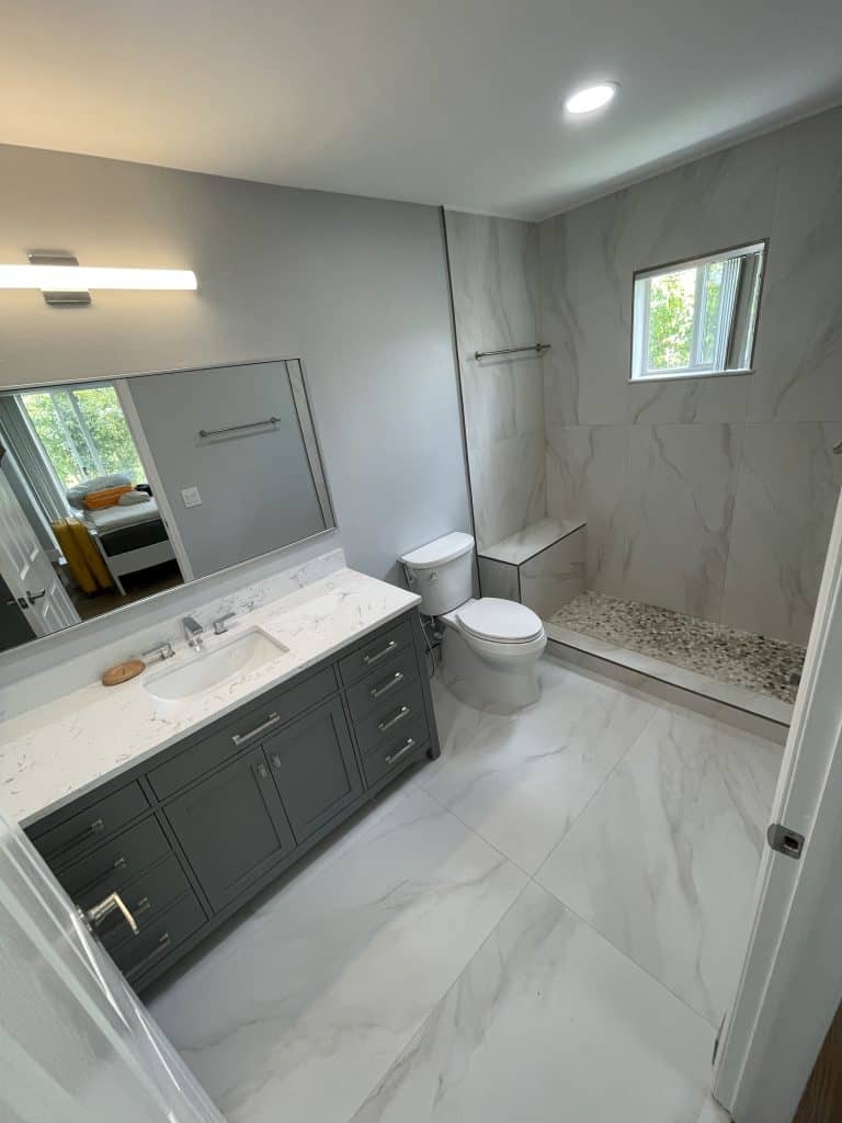 A bathroom with marble floors and a toilet.