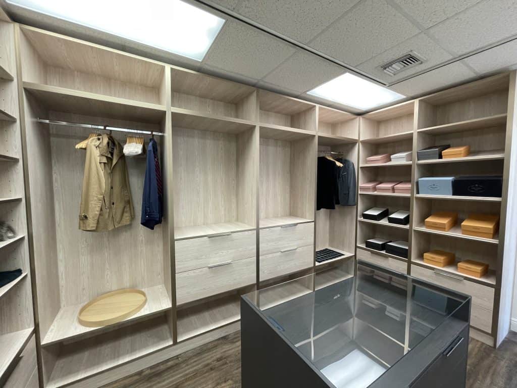 A spacious walk-in closet filled with a plethora of clothes and shoes.