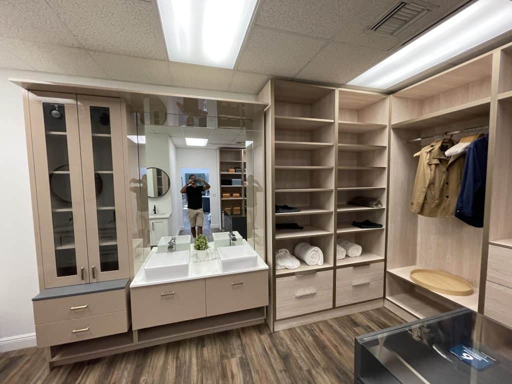 A walk-in closet featuring a sink and mirror, suitable for kitchen remodeling.